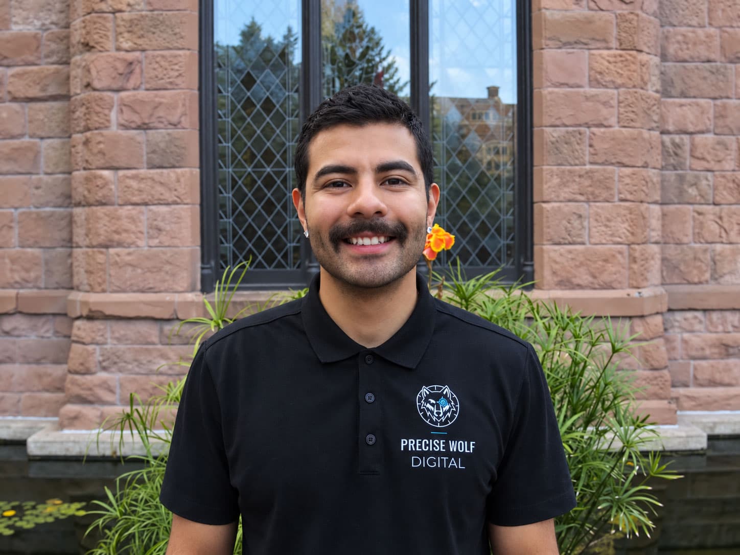 Ted Martinez, founder of Precise Wolf Digital, smiling in a Precise Wolf Digital polo